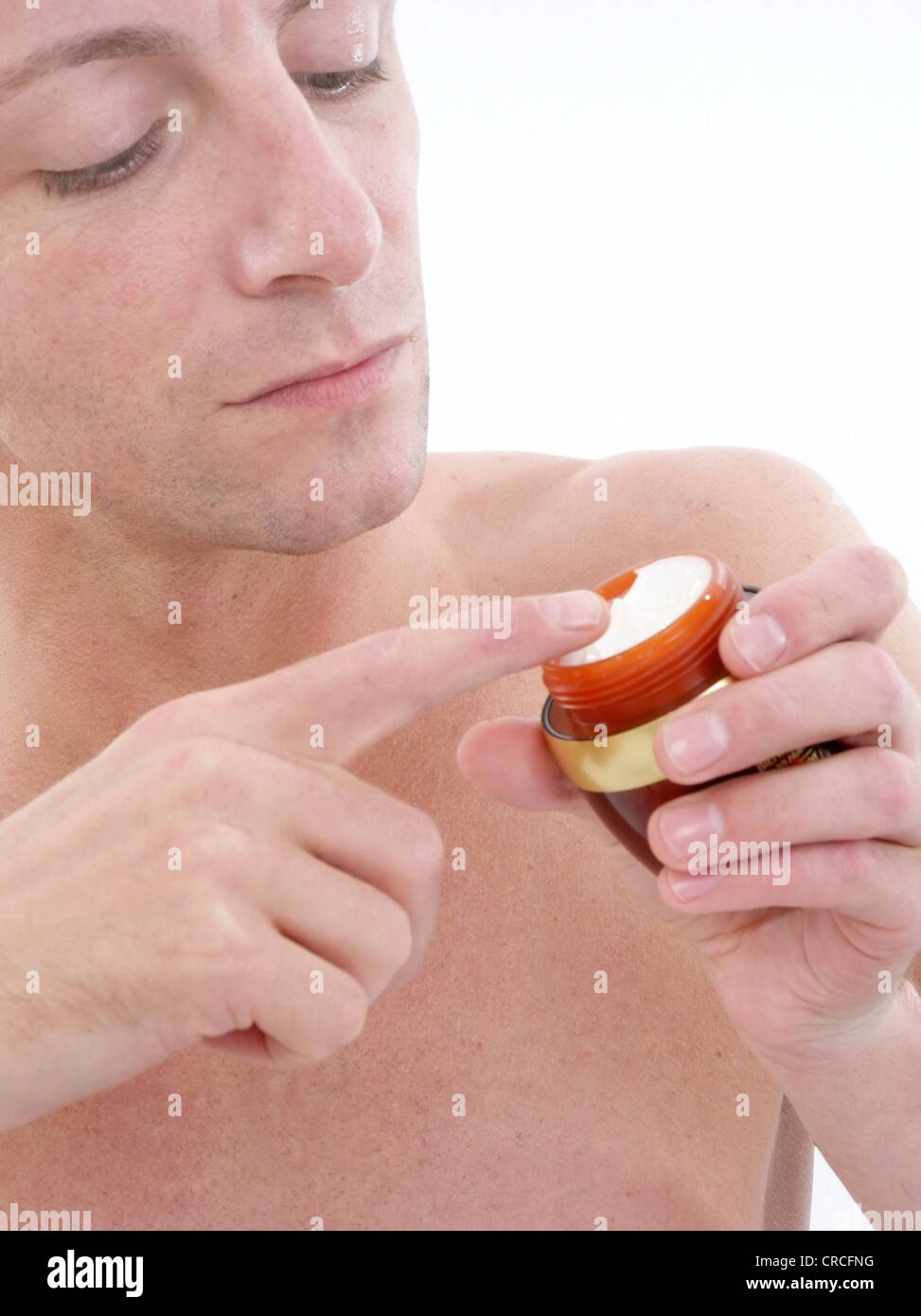 young man uses face care Stock Photo