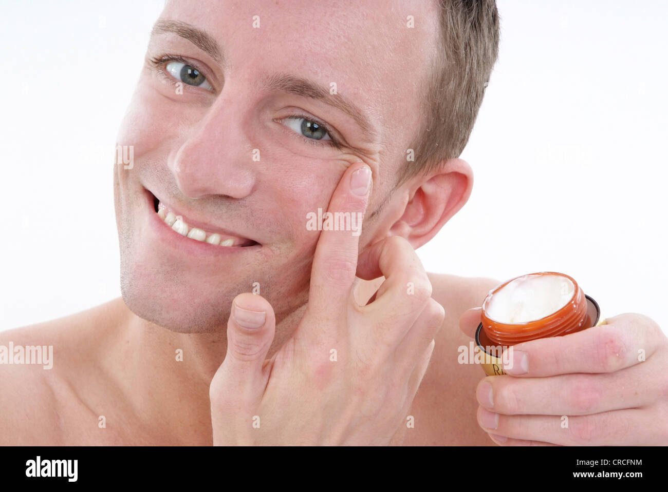 young man uses face care Stock Photo