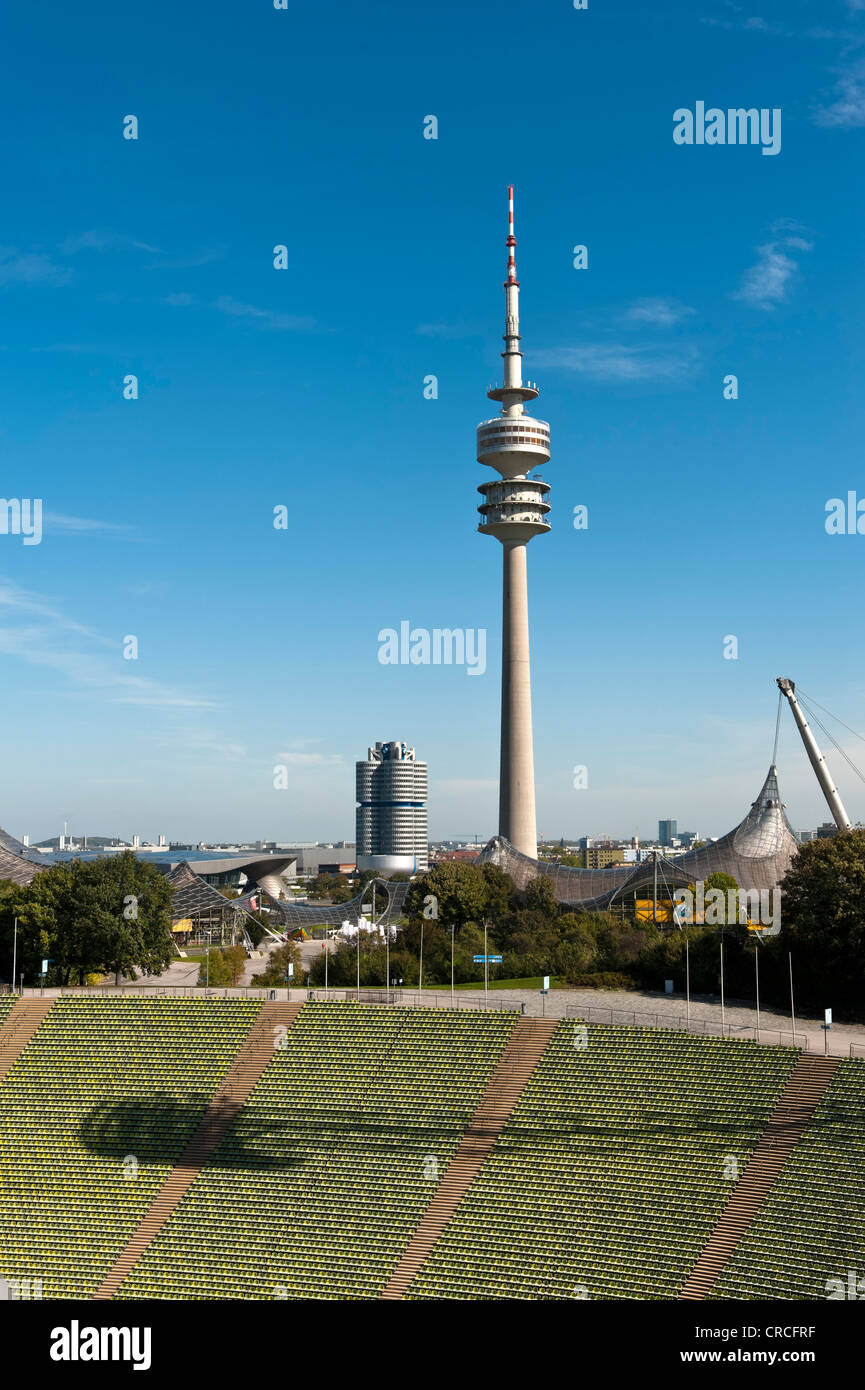 View across the seats of the Munich Olympic stadium towards the TV tower, the BMW headquarters also called "four-cylinder" Stock Photo
