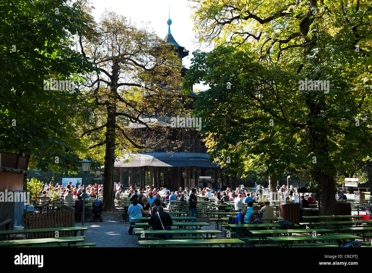 People sitting in the beer garden near the Chinese Tower in the English Garden, Munich, Bavaria, German, Europe Stock Photo