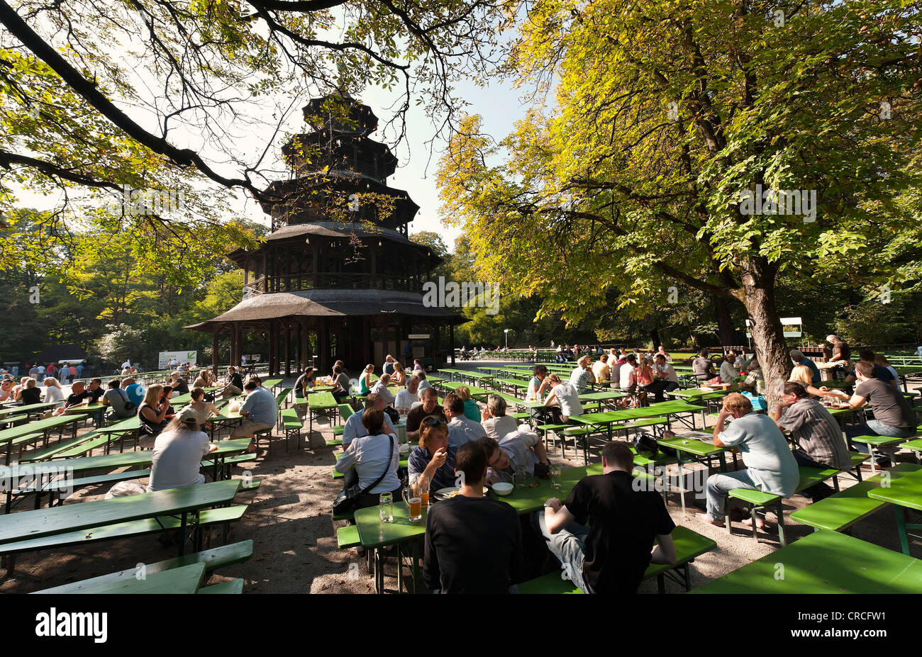 People sitting in a beer garden at the Chinese Tower int he English Garden, Munich, Bavaria, Germany, Europe Stock Photo
