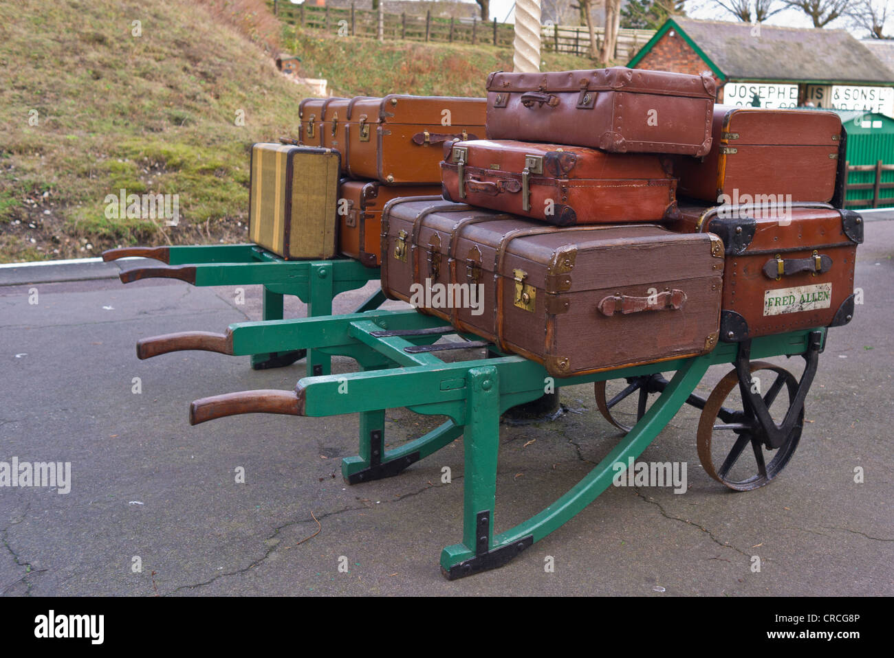 Old fashioned suitcases and trunks on station trolley at Rothley Station on the Great Central Railway Stock Photo