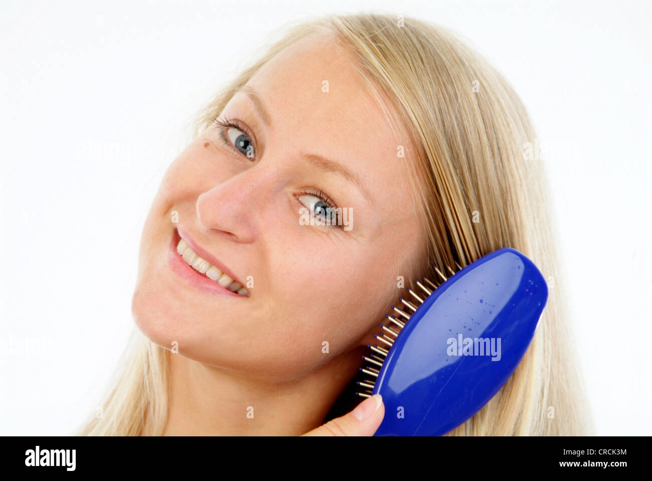 young woman brushes her long blond hair Stock Photo Alamy