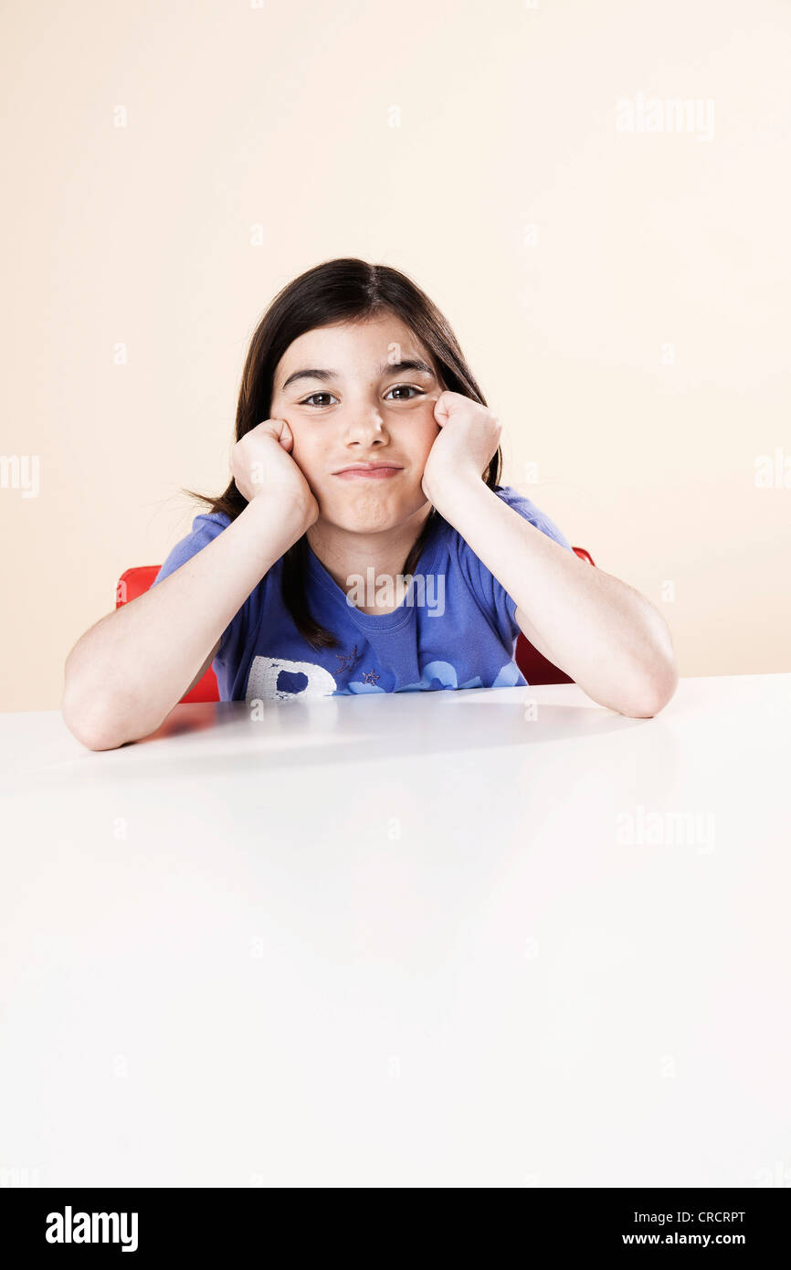 Girl resting her head in hands Stock Photo - Alamy