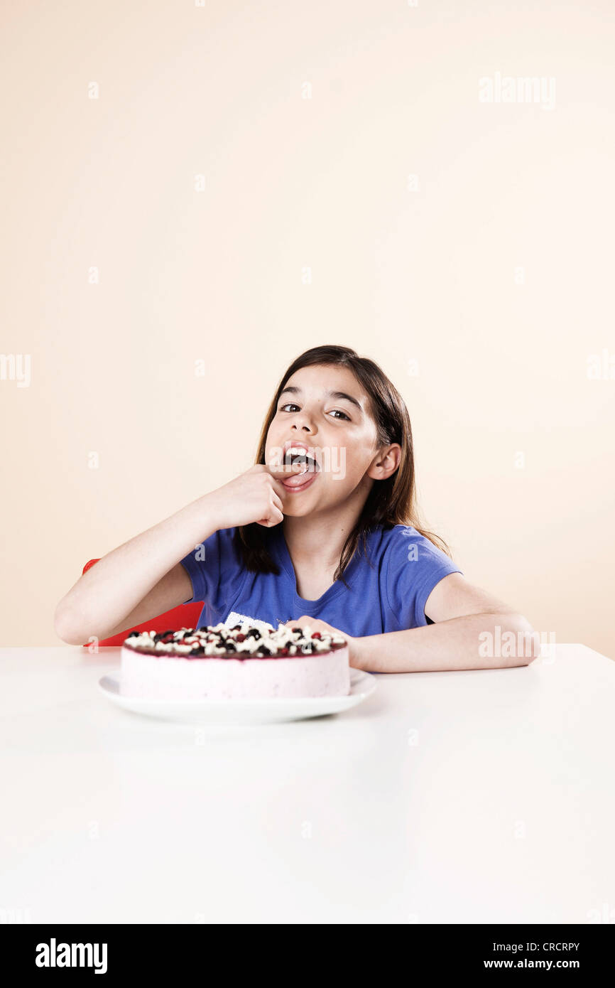 Girl nibbling from gateau Stock Photo