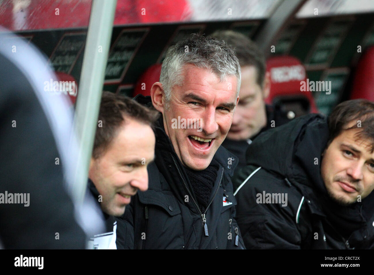 Mirko Slomka, manager of football Bundesliga club Hannover 96 laughing in the dugout, Fritz-Walter-Stadion, Kaiserlautern Stock Photo