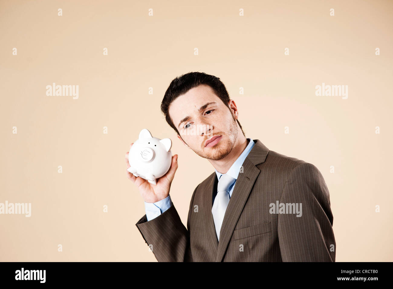 Young man with piggy bank Stock Photo - Alamy