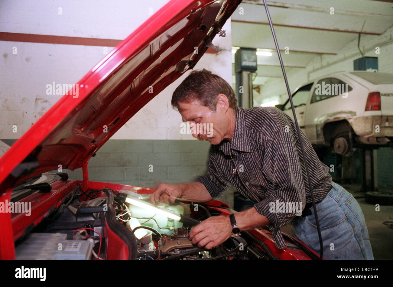 Auto repair shop, car mechanic at work Stock Photo