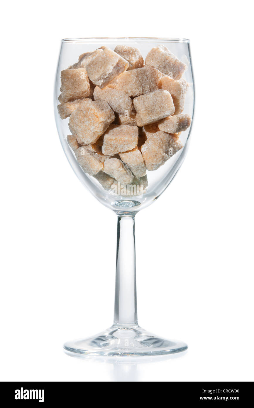 Wine glass filled with brown sugar cubes. Isolated Stock Photo Alamy