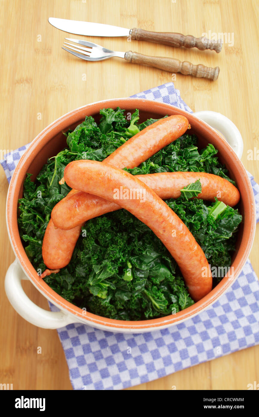 Fresh steamed kale with Mettwurst sausages Stock Photo