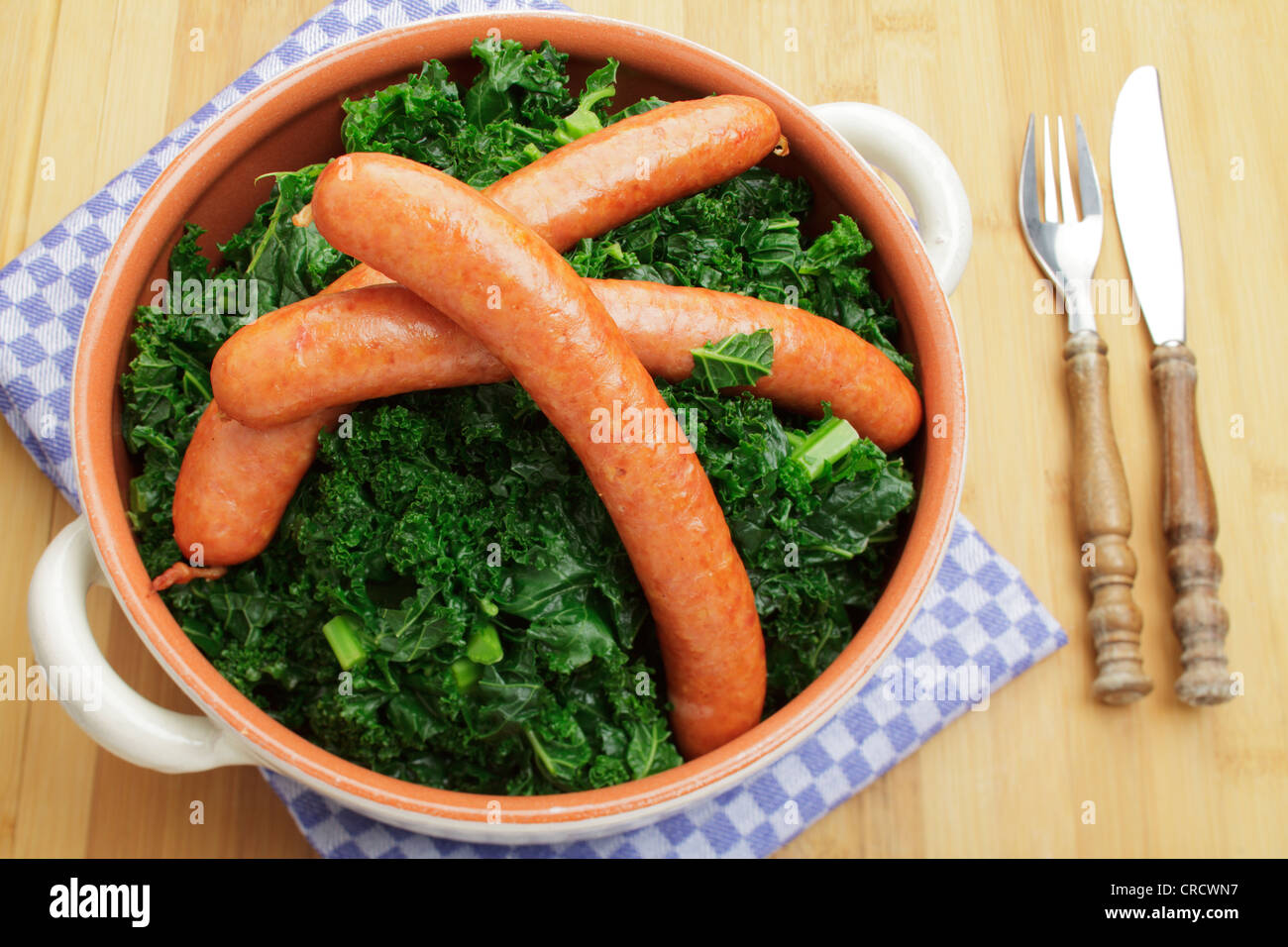 Fresh steamed kale with Mettwurst sausages Stock Photo