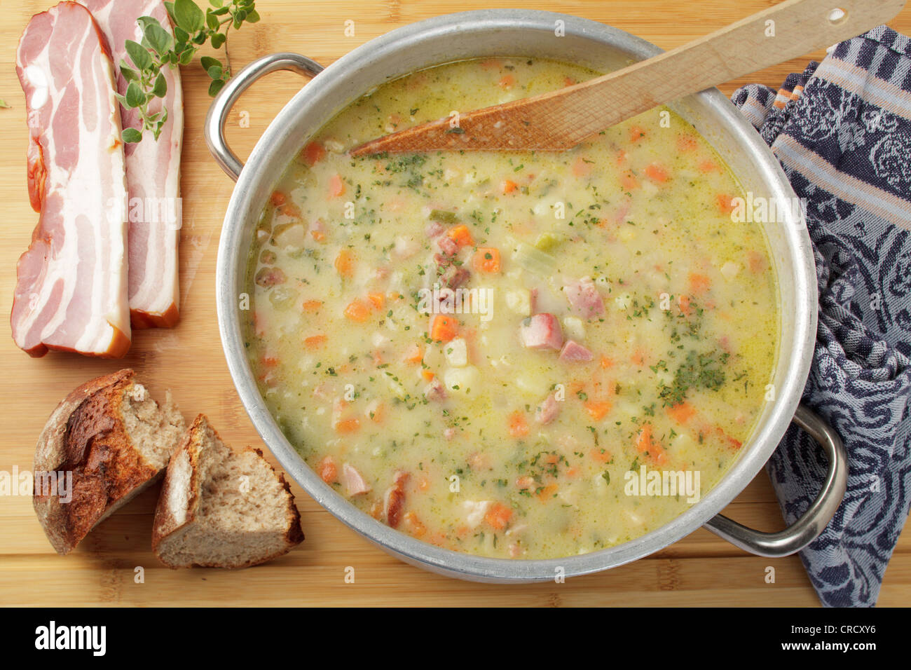 Potato soup with smoked meat cubes and bacon, bread and lean bacon Stock Photo