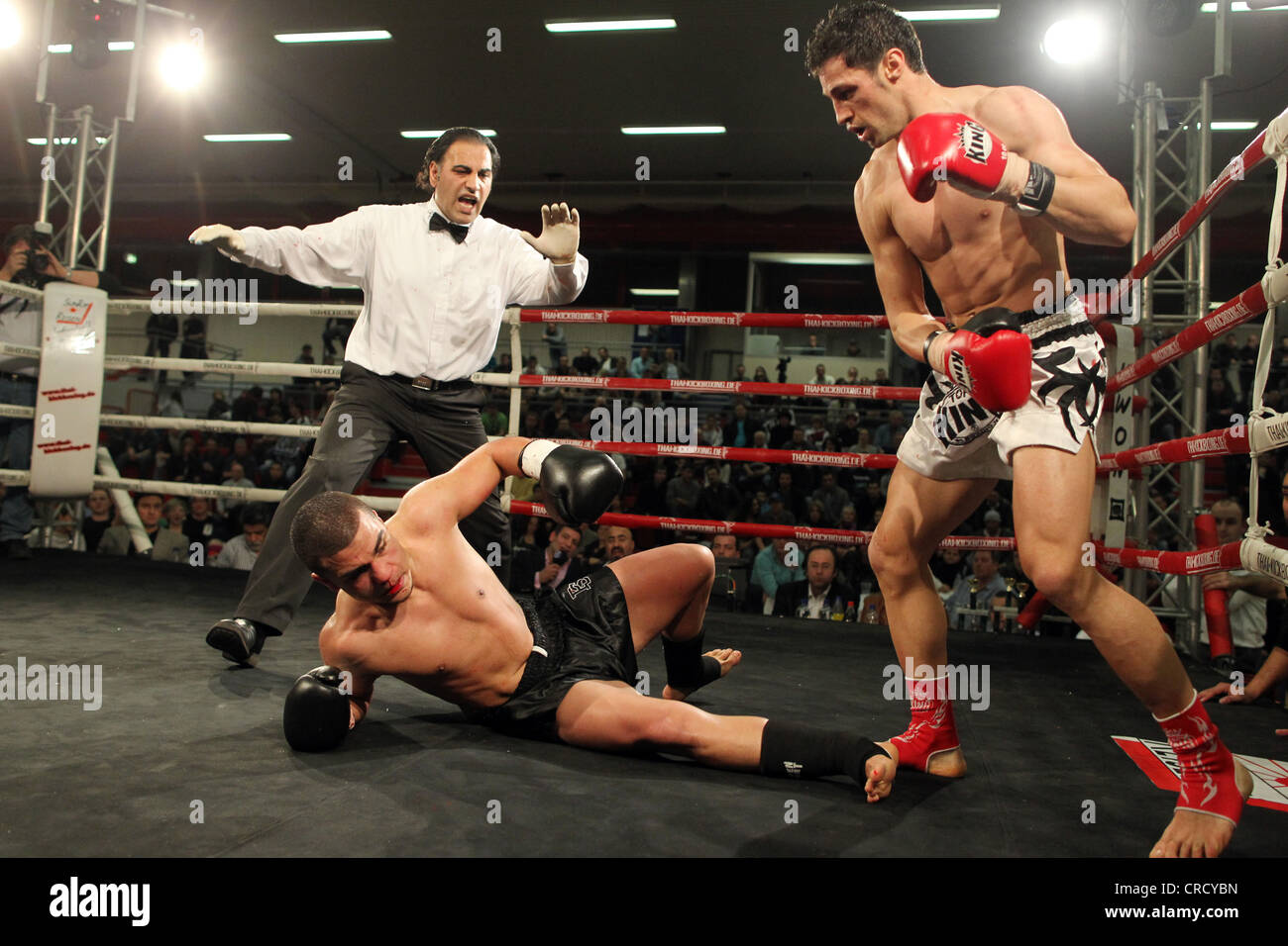 Turkish kickboxer, Kenan Er, left, losing his European title during the Fight Night against his countryman, Kenan Guenaydin Stock Photo