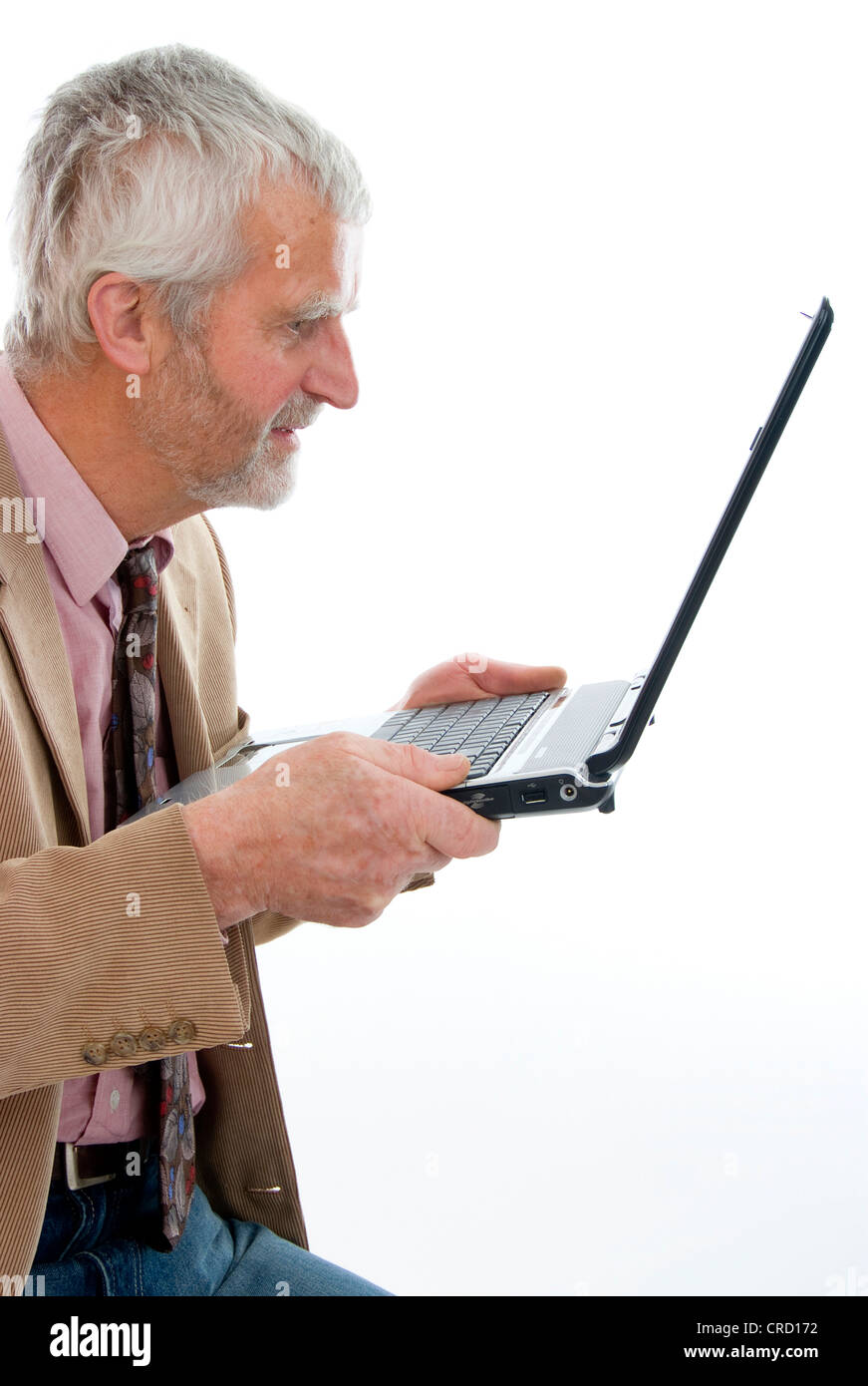 retiree gazing at his laptop Stock Photo