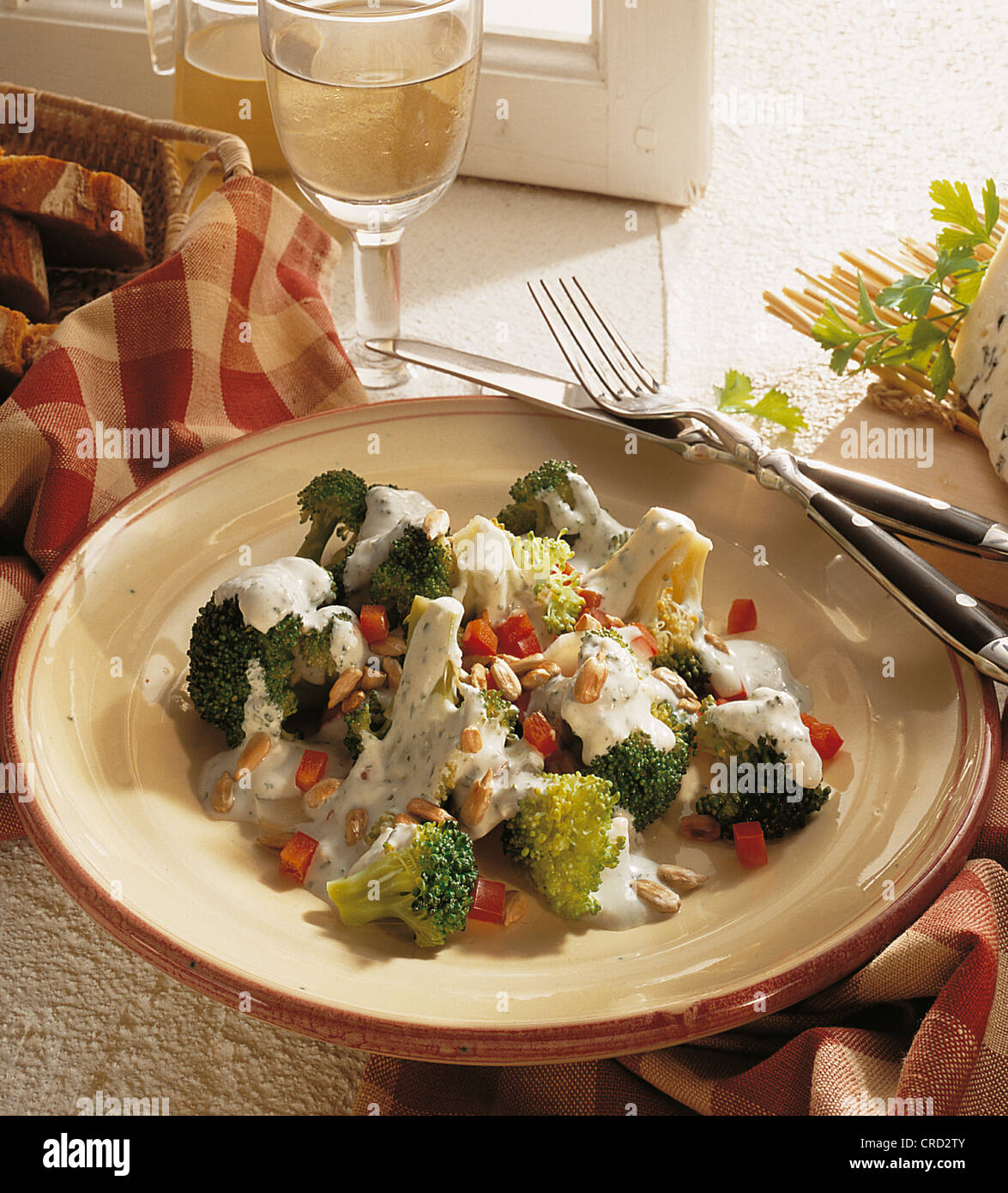 Broccoli salad with Roquefort sauce, with diced peppers and sunflower seeds, France. Stock Photo