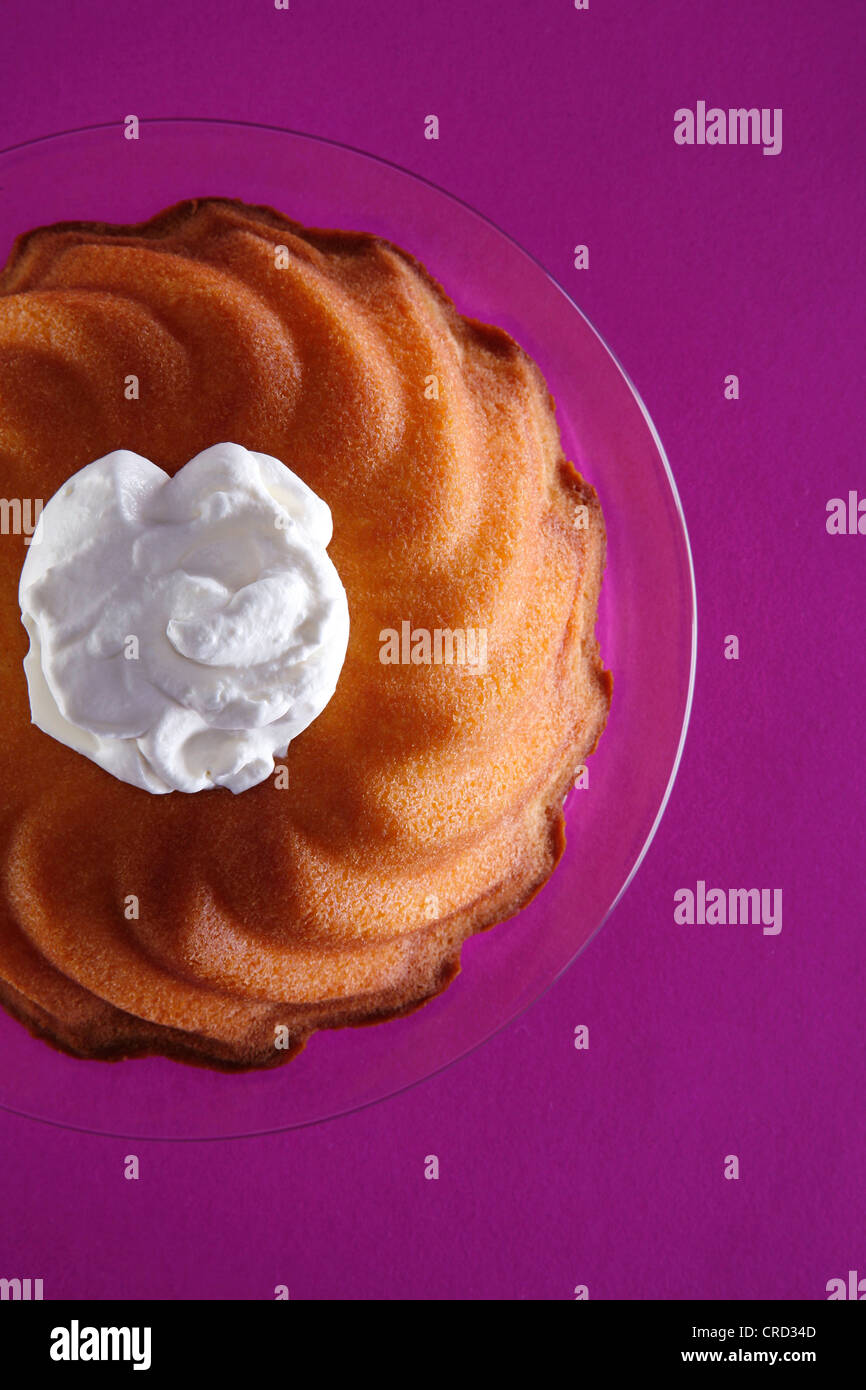 Ringshaped cake with cream blob on glass plate Stock Photo Alamy