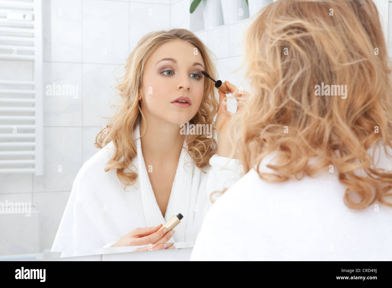 Young woman making up Stock Photo