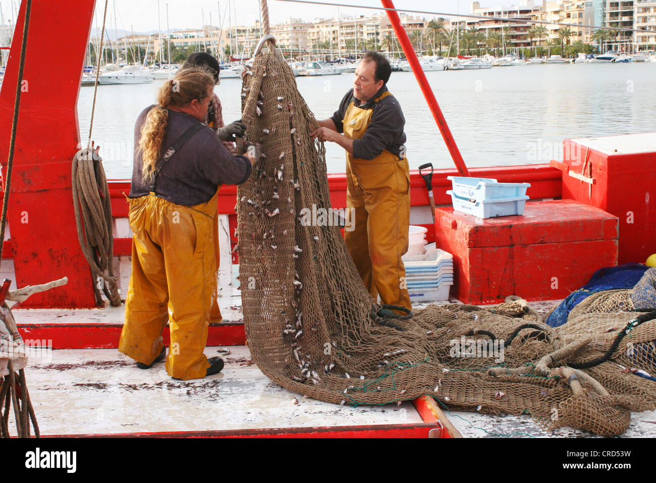 Fishermen cleaning nets hires stock photography and images Alamy