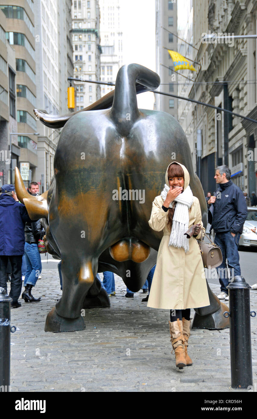 afro-american woman in front of the bull of the Wall Street, USA, New York City, Manhattan Stock Photo