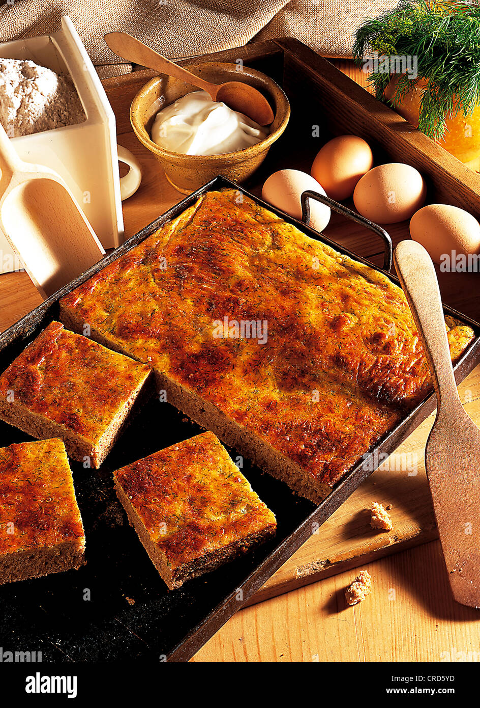 Baking tray bread from Transylvania, sourdough with a layer of Brinza feta, egg, sour creams and dill, Romania Stock Photo