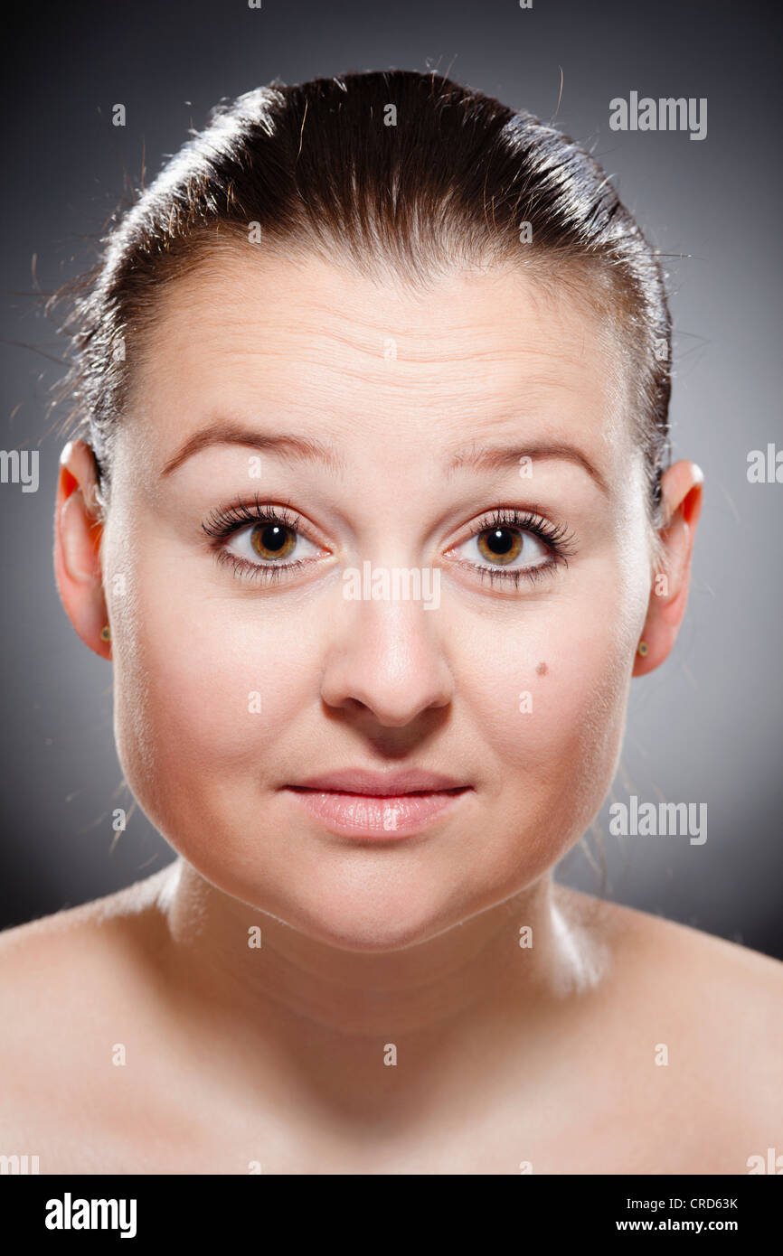 Young woman with a questioning glance Stock Photo