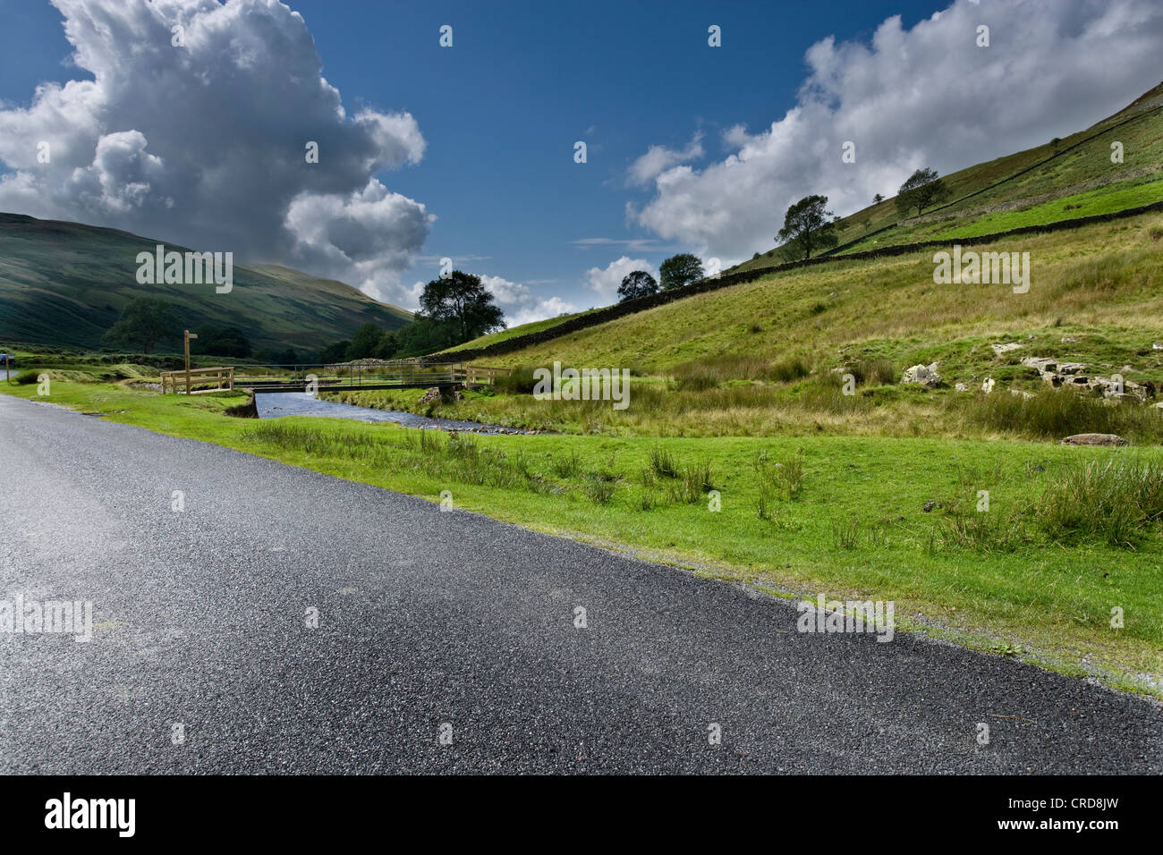 country roads in the Lake district uk cgi car backgrounds summer fluffy clouds hills Stock Photo