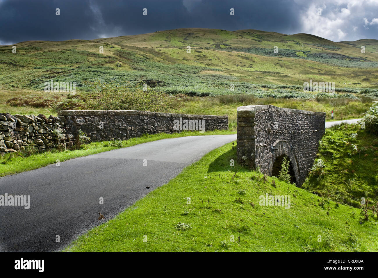country roads in the Lake district uk cgi car backgrounds summer fluffy clouds hills Stock Photo