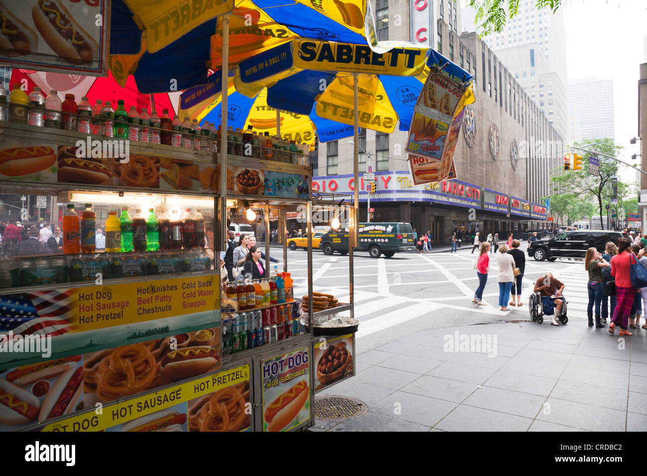 Typical food cart selling freshly cooked hot dogs & pretzels on the streets  of Manhattan, New York city opp Radio City Stock Photo - Alamy