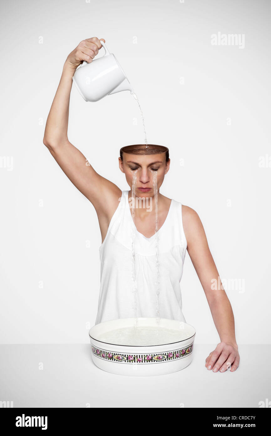 Weeping woman with endless tears, symbolic image for mourning, composing Stock Photo