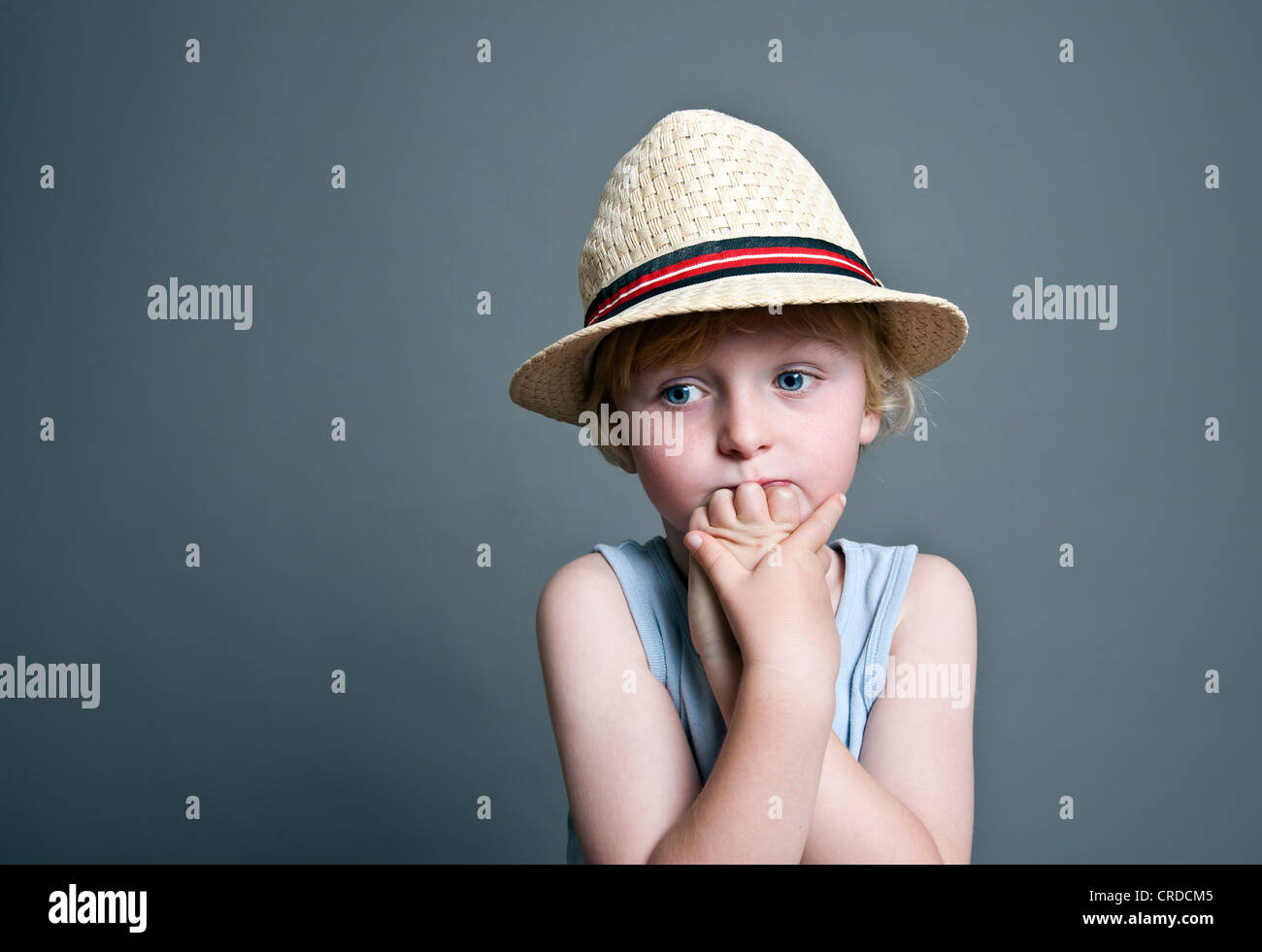 Fiveyearold boy wearing a hat, sad face, portrait Stock Photo Alamy