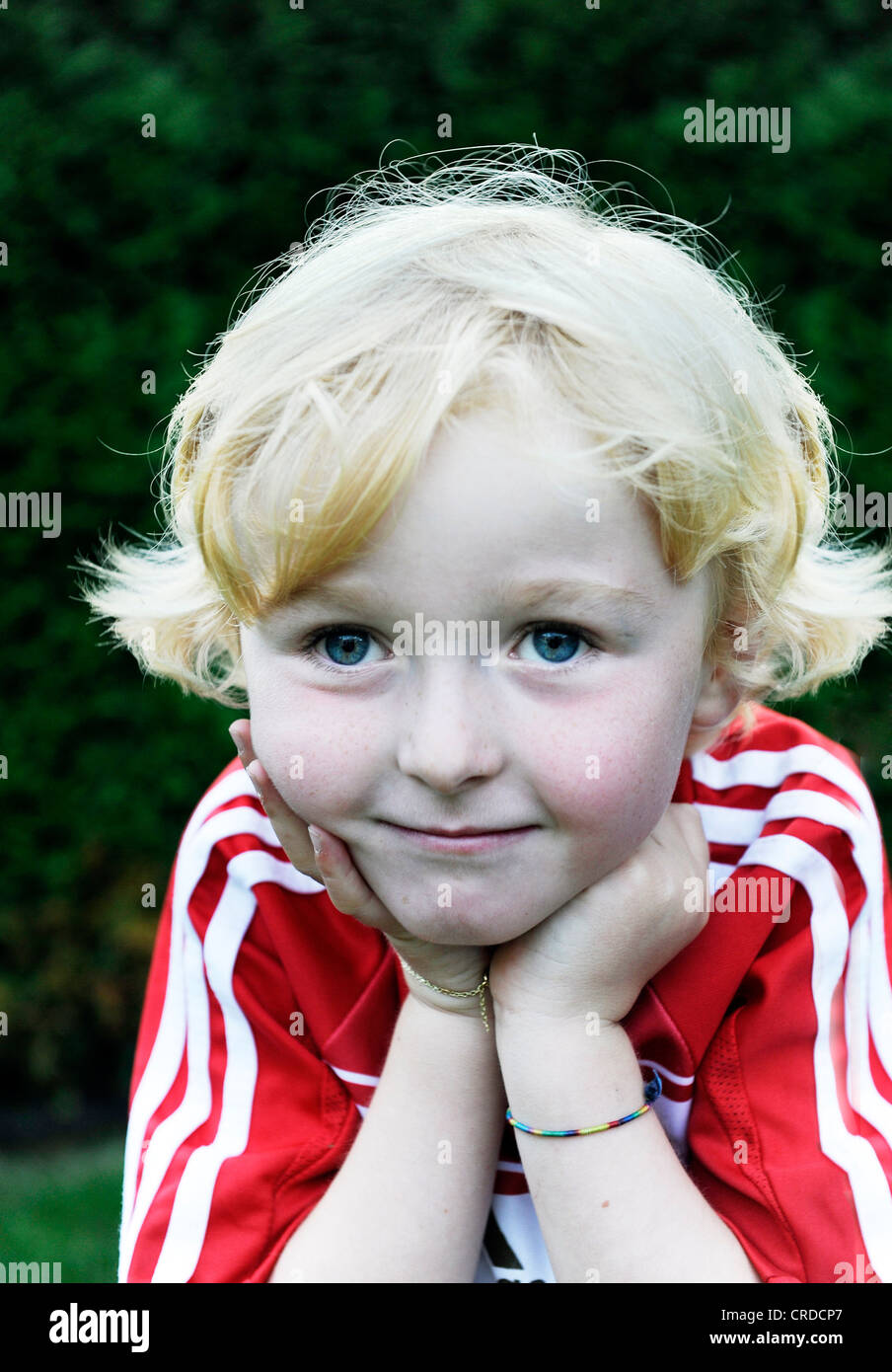 Fiveyearold boy wearing a FC Bayern Munich soccer dress, head resting
