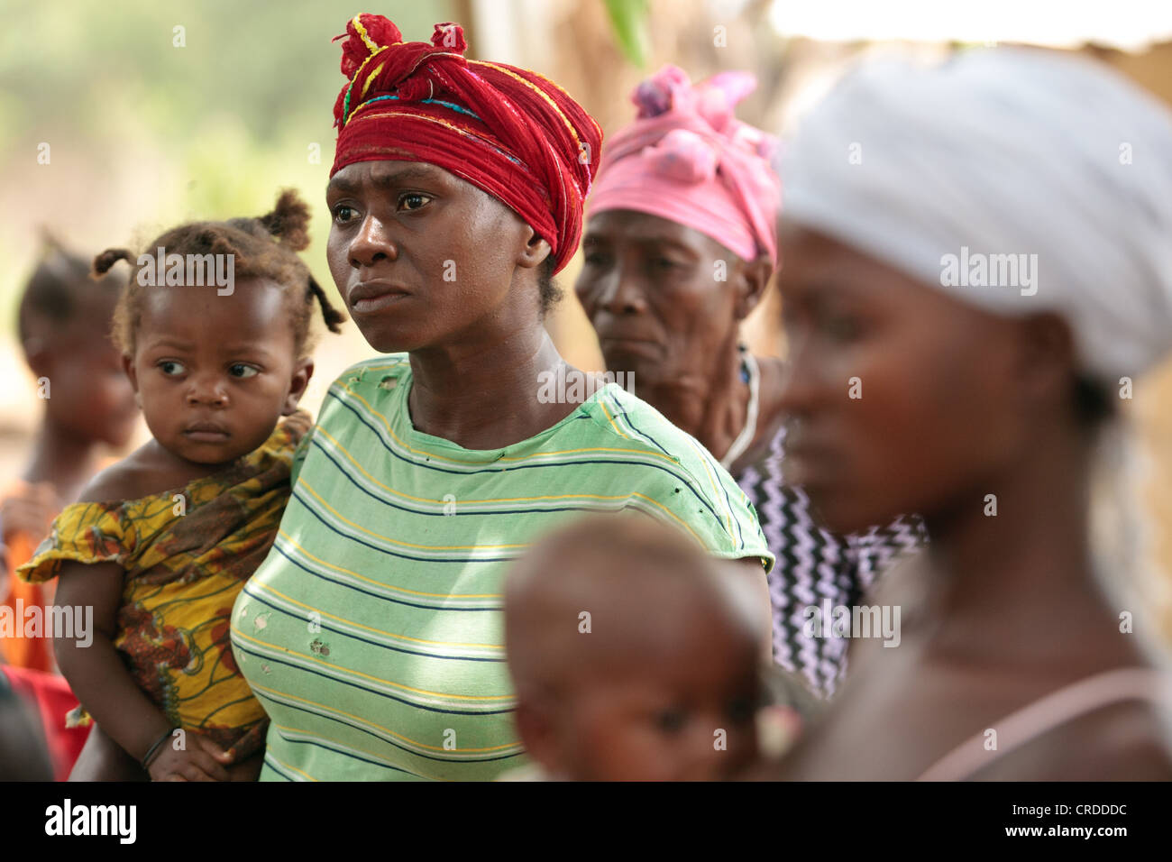 Jenneh Johnson, 31, a mother of six, waits to receive money from a social cash transfer programme in the village of Julijuah Stock Photo