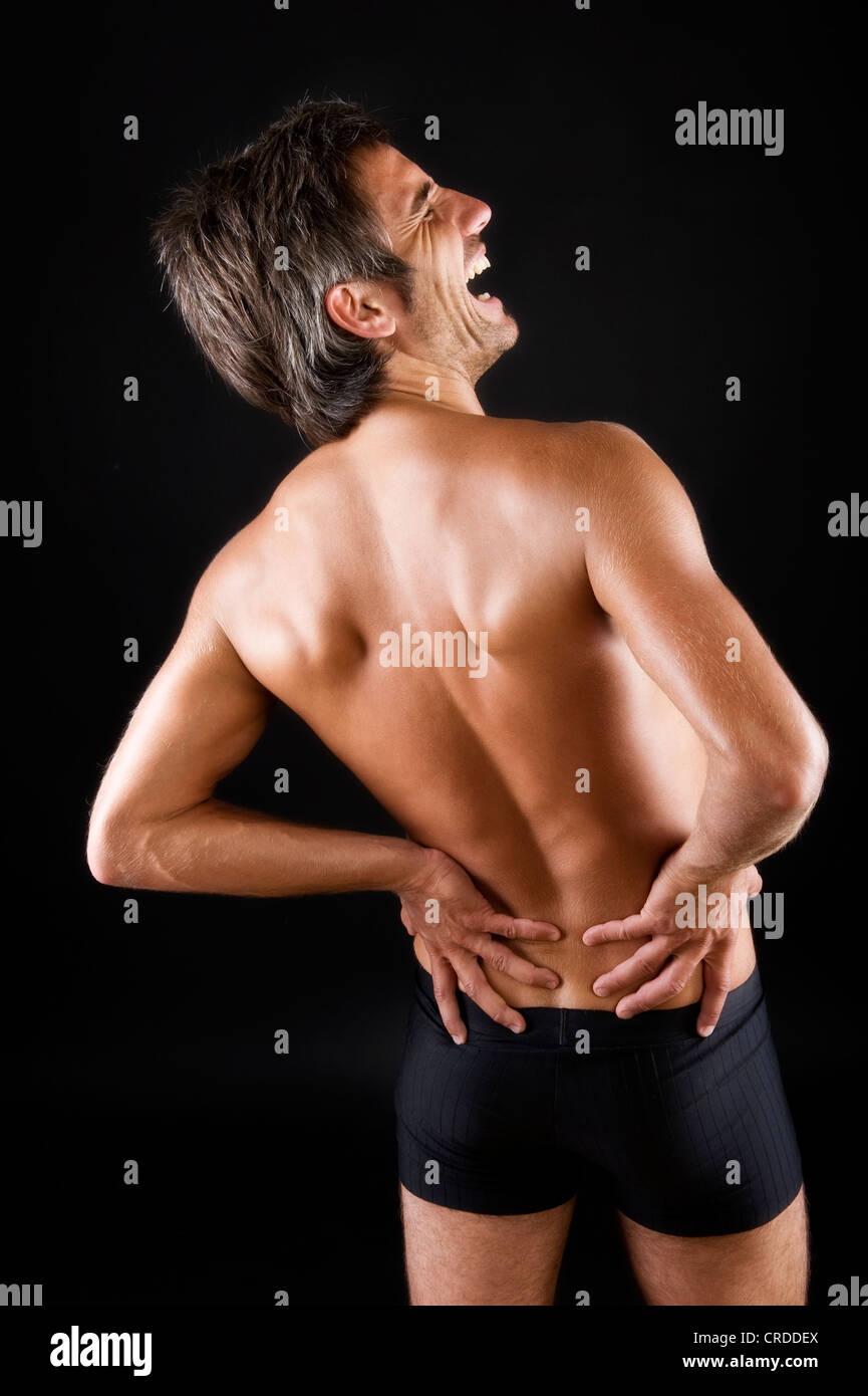 Crying man with back pain, cry of pain Stock Photo