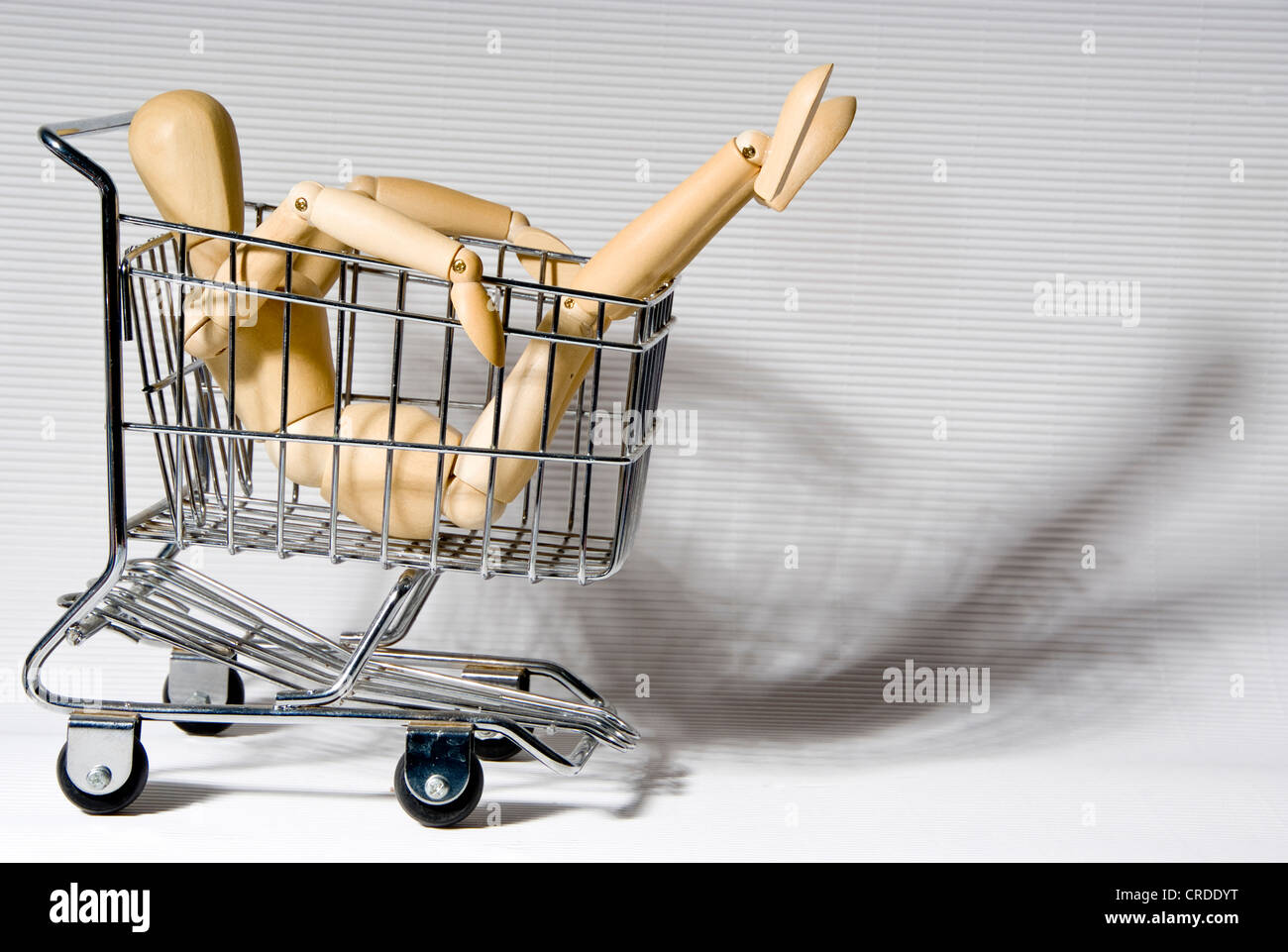 jointed doll in shopping trolley Stock Photo