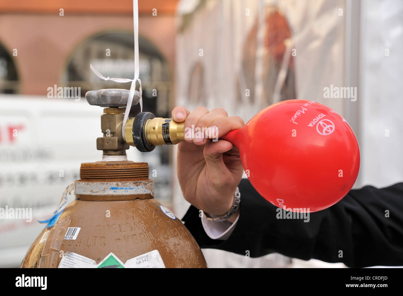 Balloon attached to helium bottle being inflated Stock Photo