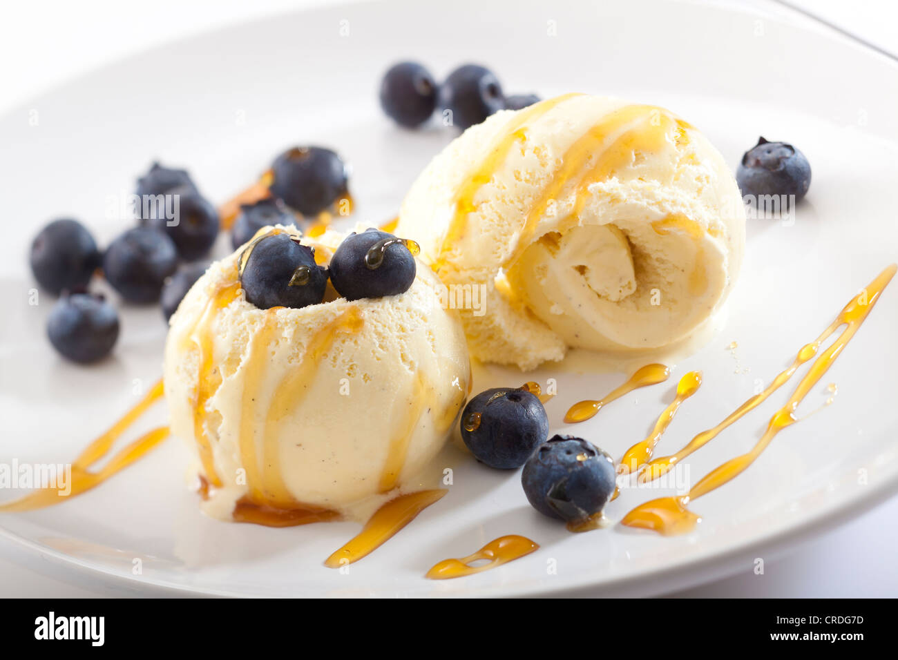 Vanilla ice cream with blueberries and honey Stock Photo Alamy