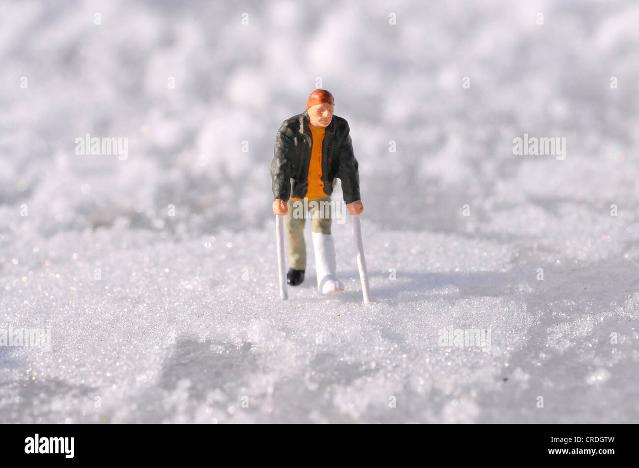 Figure with leg in plaster in snow Stock Photo