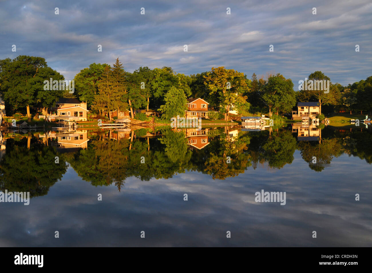Houses reflected in the lake, Okauchee Lake, Wisconsin, USA Stock Photo