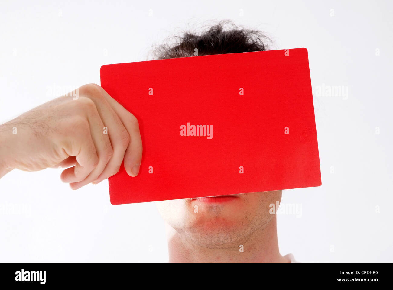 man showing red card in front of his face Stock Photo