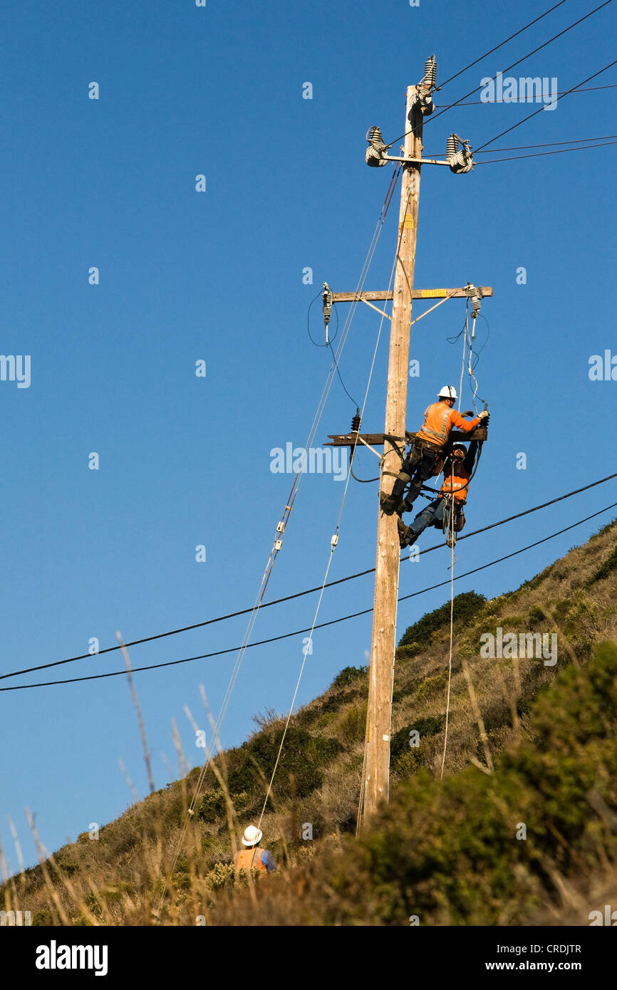 Workers of the PG&E power company working on a pylon, Big Sur, California, USA Stock Photo