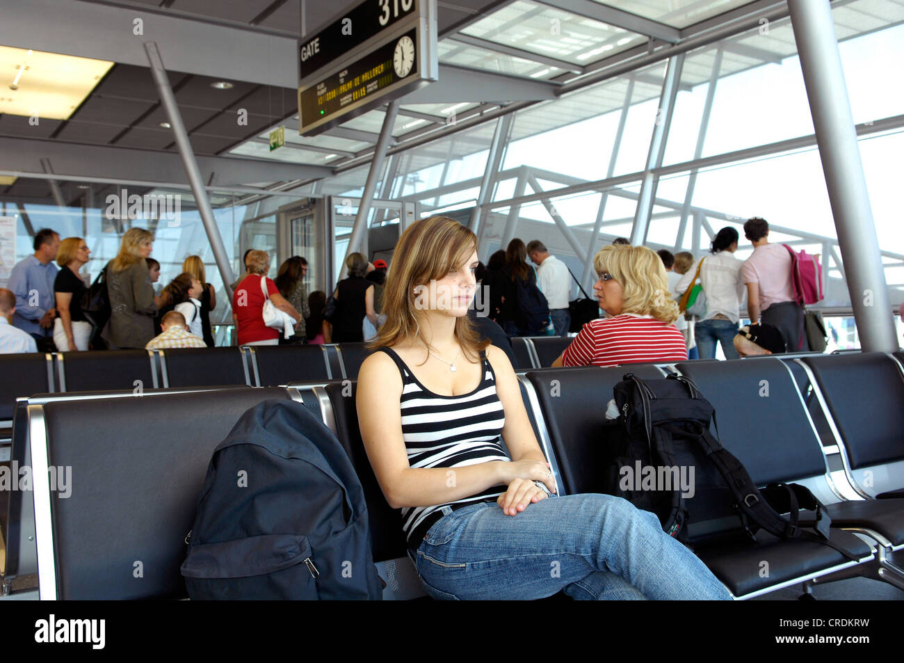 young woman sitting and waiting at the airport Stock Photo