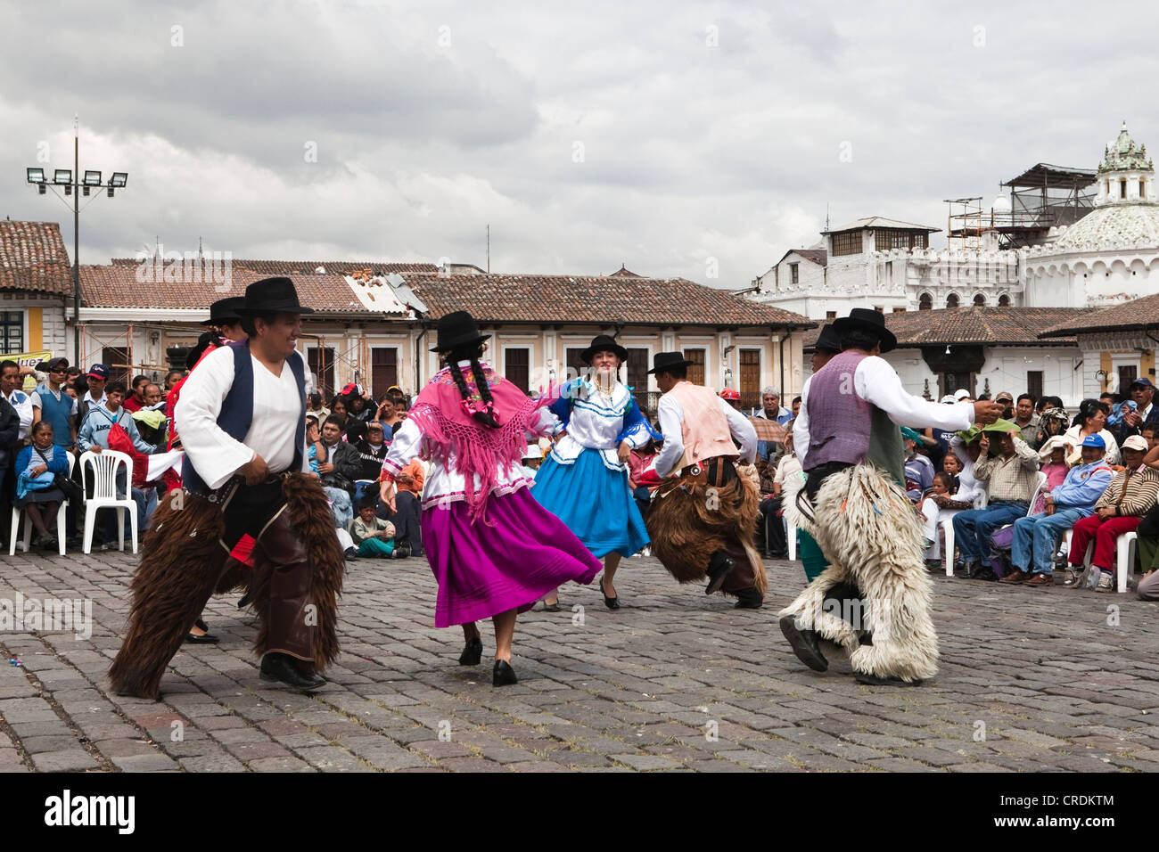 Costume dance groups on the Plaza San Francisco during a car-free Sunday in the historic town centre of Quito, Ecuador Stock Photo