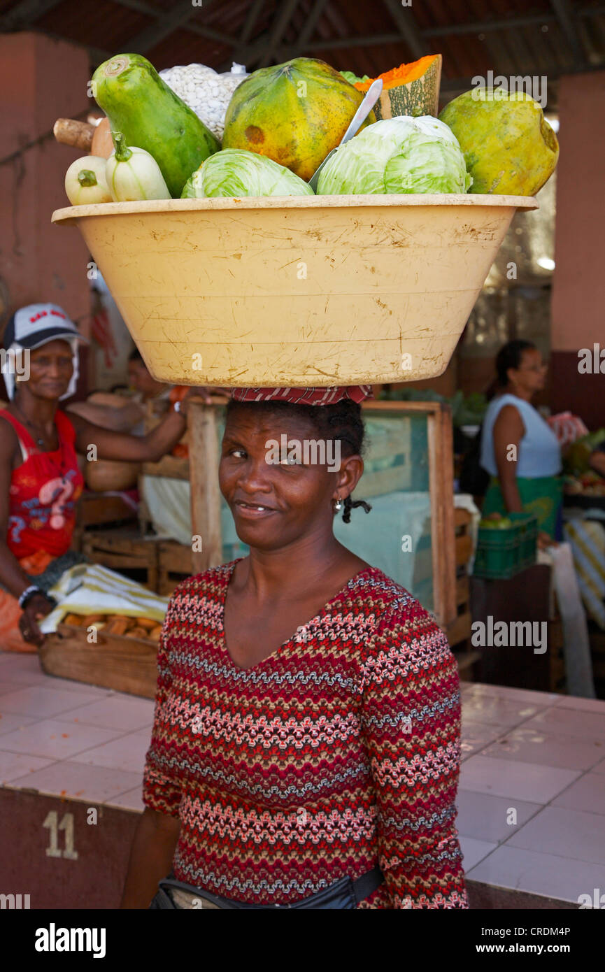 at the market; woman carrying cabbage on her head, Cap Verde Islands, Cabo Verde, Fogo, Sao Filipe Stock Photo