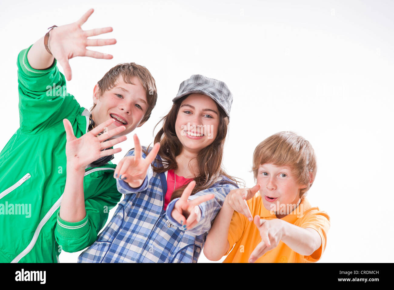 Three Friends One Girl And Two Boys Posing Gesturing Smiling Stock Photo Alamy