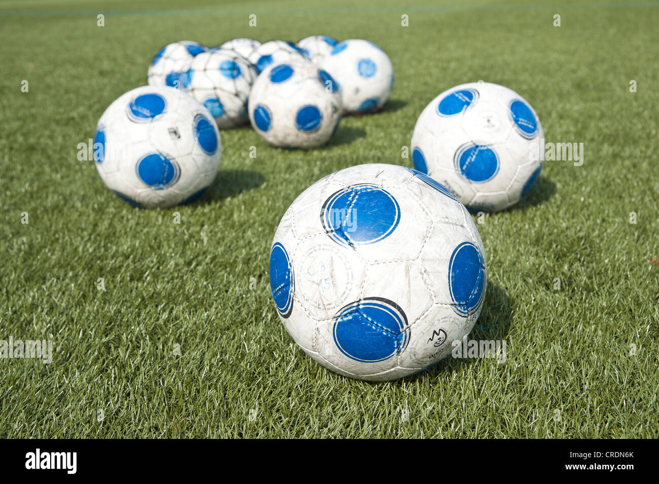 Several footballs on artificial grass pitch Stock Photo Alamy