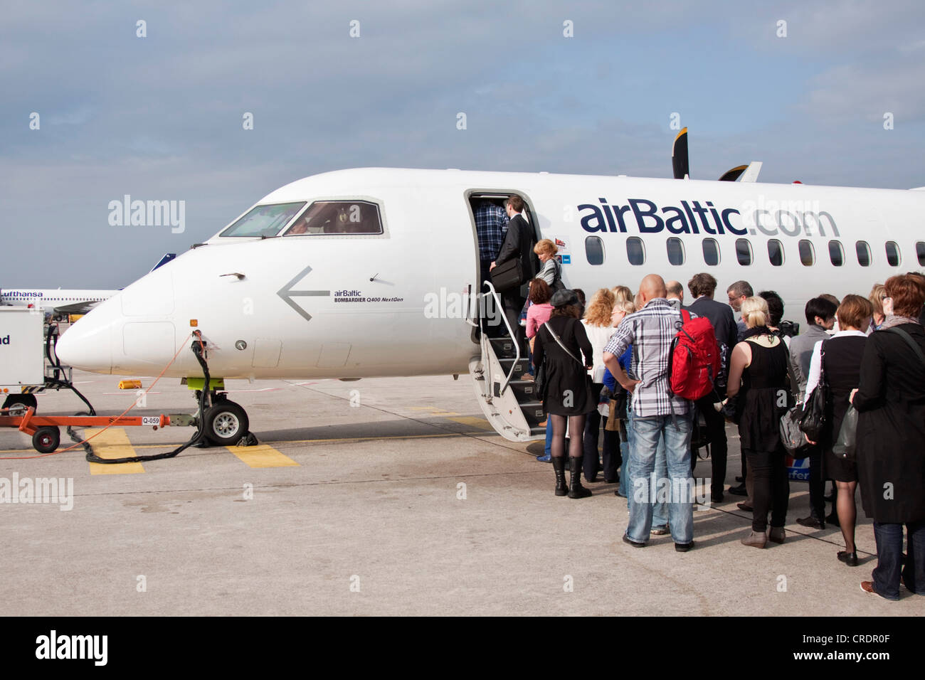 Passengers boarding an Air Baltic Bombardier Q 400 Next Gen aircraft, Berlin Tegel Otto Lilienthal Airport, Berlin Stock Photo