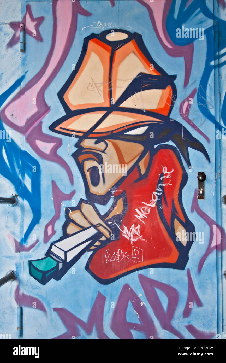 Graffiti on a door with a man in a cap smoking a joint, marijuana, drug Stock Photo