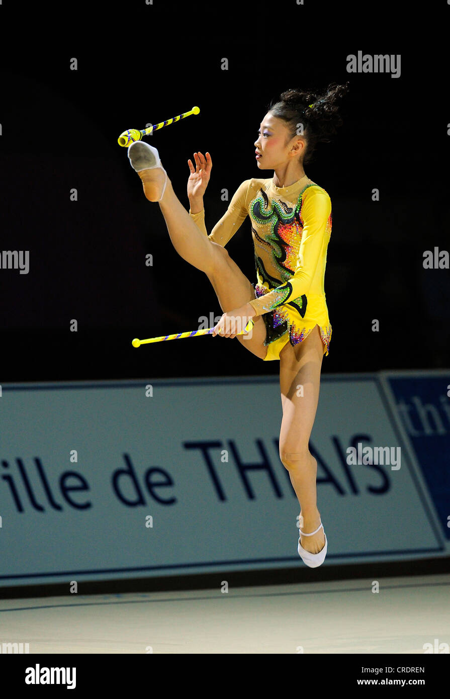 woman doing rhythmic gymnastics with clubs Stock Photo