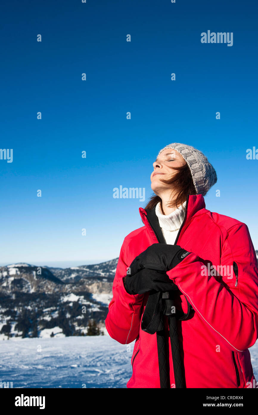 Nordic walking woman in the snow in the mountains Stock Photo