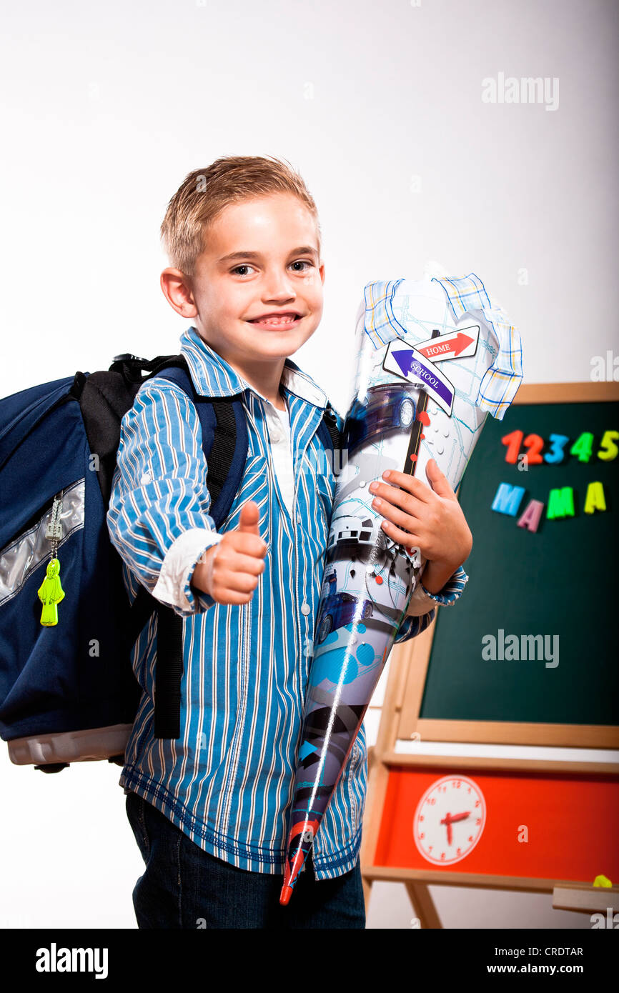 A first grader school boy with school bag and First-Day-of School-cornet Stock Photo